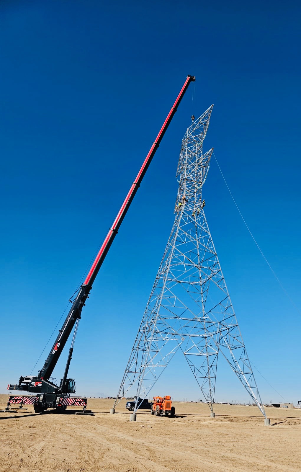 Transmission tower construction with crane