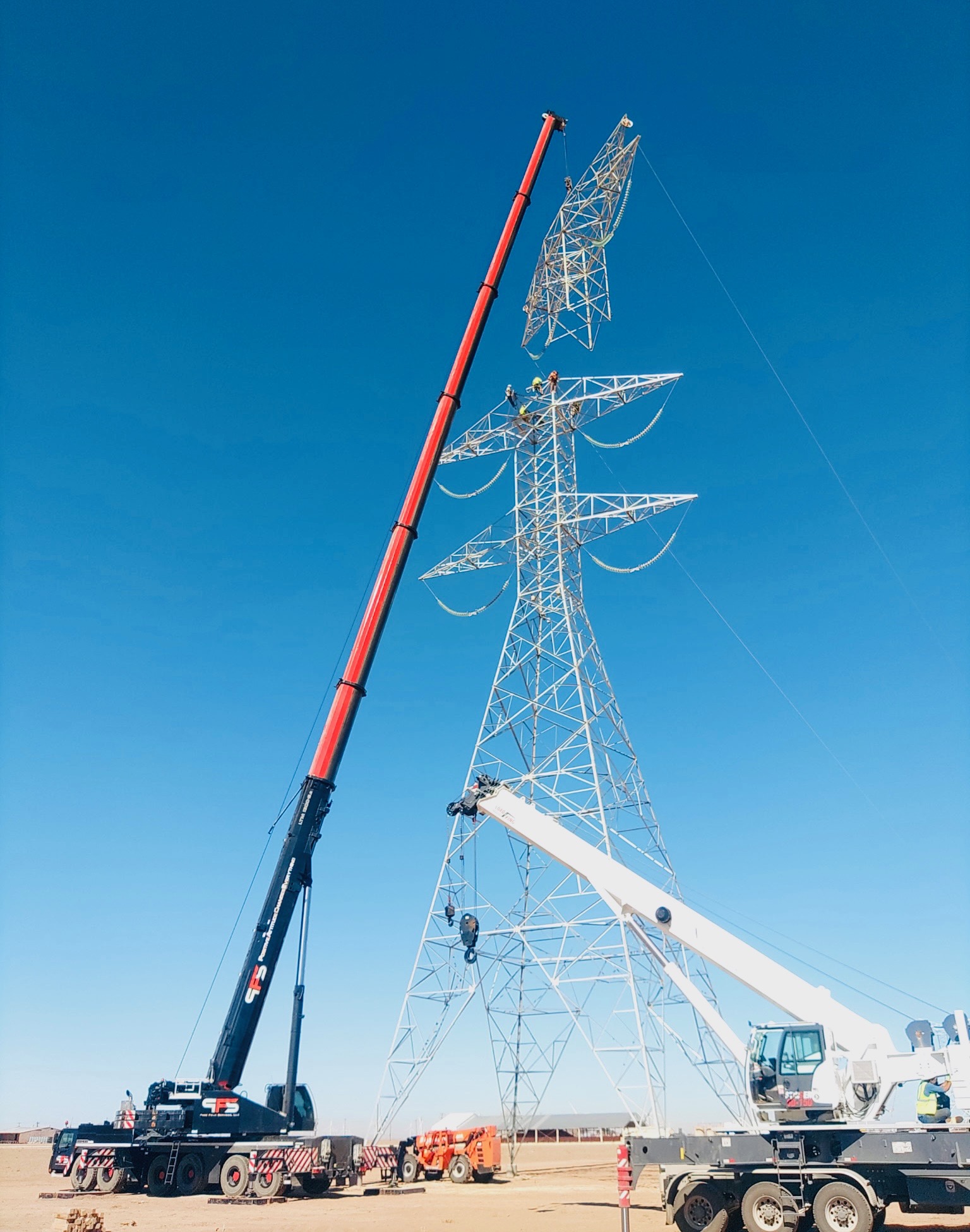 Dual crane operation on transmission tower